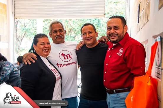 Eric Sánchez Árciga abrazando a integrantes de la comunidad durante una reunión